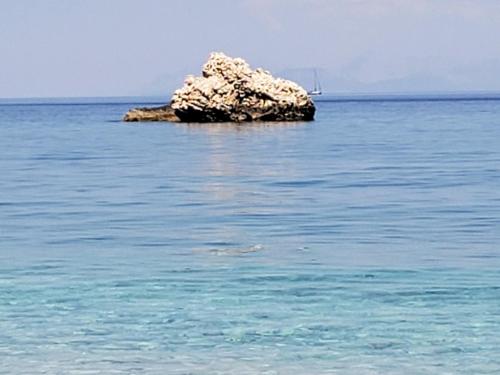 a small rock in the middle of the ocean at Dennis Seaview in Póros Kefalonias