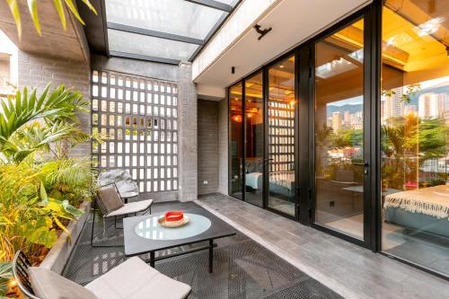 a balcony with a table and chairs on a building at Primavera Luxury Apartments Medellin in Medellín