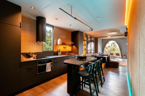 a kitchen with a table and chairs in a room at Primavera Luxury Apartments Medellin in Medellín
