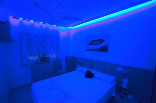 a room with a bed with blue lights on it at Apartalux Magic Gold in Oropesa del Mar