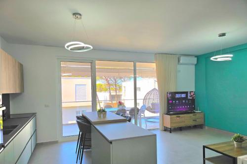 a kitchen with blue walls and a table with a counter top at Swiss Sweet Apartment 297 - Happy Rentals in Lalzit Bay