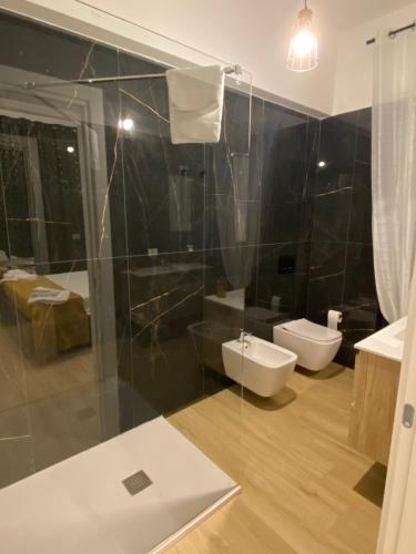 a bathroom with a toilet and a shower and a sink at Le Margherite in Montesilvano
