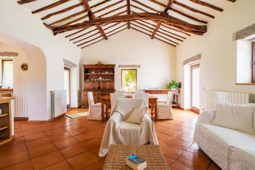 a living room with a couch and a table at North Sardinia Retreats Stazzo Liccia Barria - villa con piscina in Arzachena