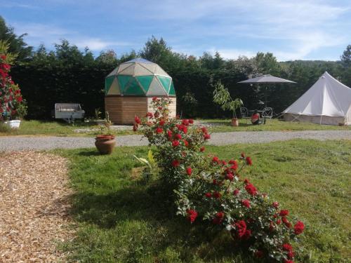un belvédère et une tente dans un champ de fleurs dans l'établissement La Tente Tipi au Ranch du Bonheur, à Tourtouse