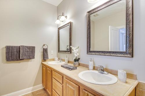 a bathroom with two sinks and a mirror at Bright Biloxi Condo Walk to the Beach! in Biloxi