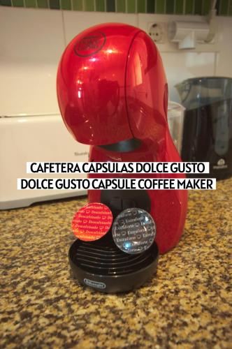a red coffee maker sitting on top of a counter at Apartalux Magic Gold in Oropesa del Mar