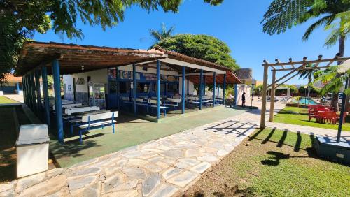 a building with benches and tables in a park at Acqua Ville 2 - Apartamentos JN in Caldas Novas