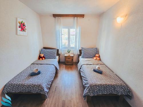 a small room with two beds and a window at Two rooms Hvar spa & apartments in Vrboska