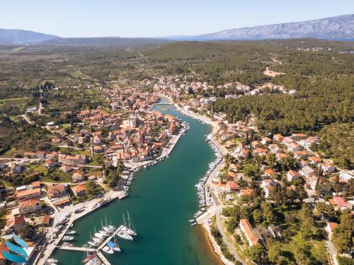an aerial view of a town next to a river at Two rooms Hvar spa & apartments in Vrboska