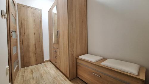 a room with a closet with a bench and a mirror at Domek pod jabloní in Tichá