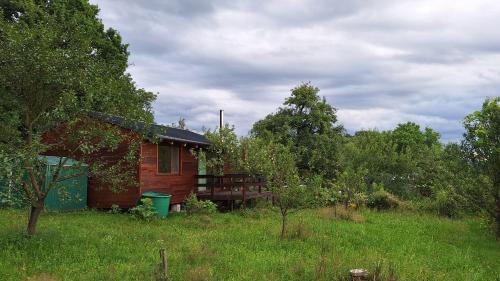 a small house in the middle of a field at Domek pod jabloní in Tichá