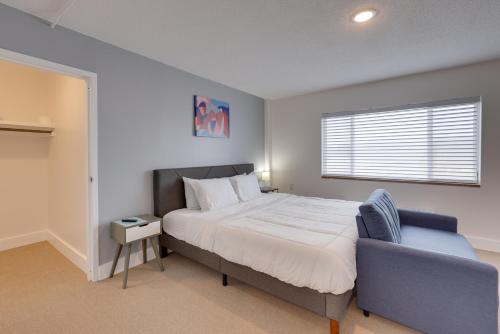 a bedroom with a bed and a chair and a window at Studio in Gadsden about 10 Mi to the Coosa River! in Gadsden