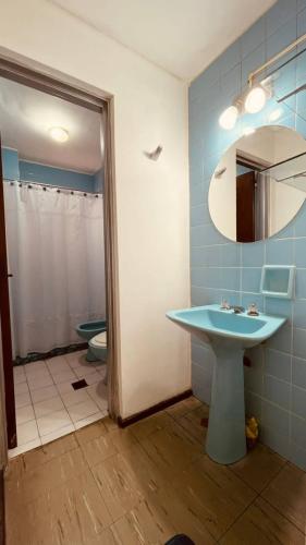 a bathroom with a sink and a mirror and a toilet at Black Sheep International Hostel in Mendoza