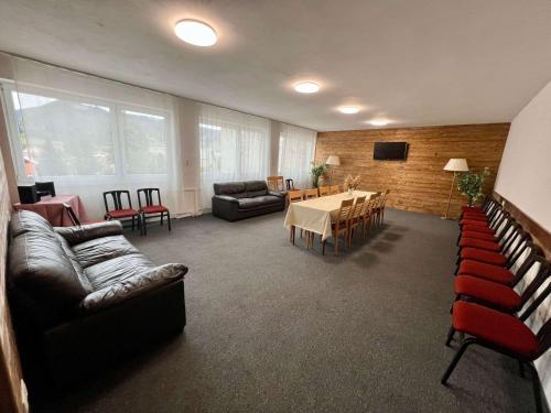 a living room with couches and a table and chairs at Hotel Telgárt - Turistické ubytovanie in Telgárt