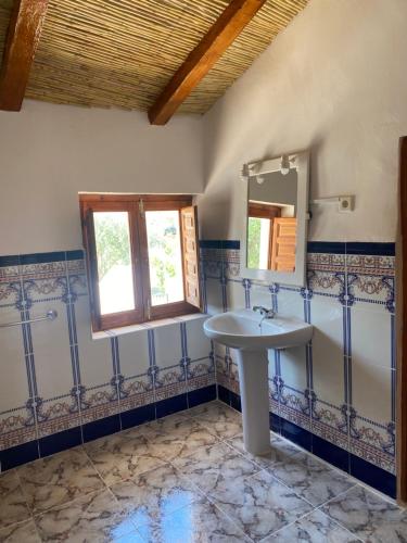 a bathroom with a sink and a mirror at Luby Cortijo el Tío Emilio in Lubrín