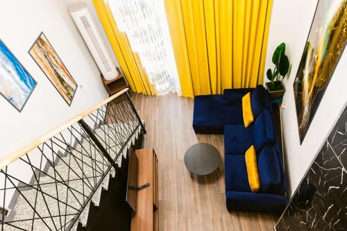 an overhead view of a living room with blue and yellow furniture at Andor Luxury Hotel & Duplex in Durrës