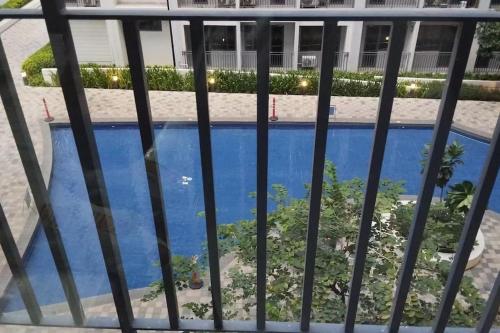 a view of a swimming pool from a balcony at E & R Staycation Condotel near Mall of Asia in Manila