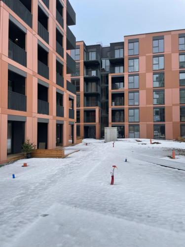 an empty parking lot in front of a building at 11 New Airport Apartment - Nedirba in Vilnius