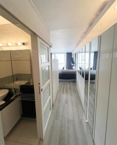 - un couloir d'une salle de bains pourvue d'un lavabo et d'un miroir dans l'établissement Apartment Like HOME Arc de Triomphe, Champs Élysées, Tour Eiffel, à Paris