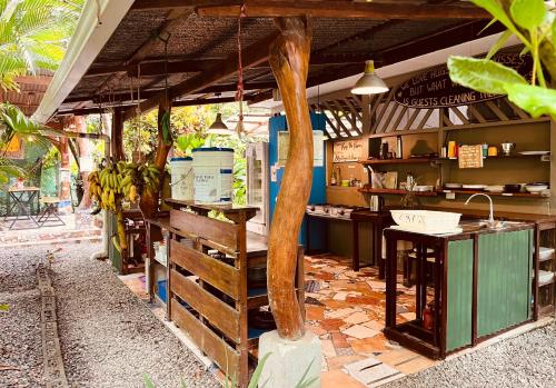 a kitchen with a counter with bananas on it at La Ruka Hostel in Puerto Viejo
