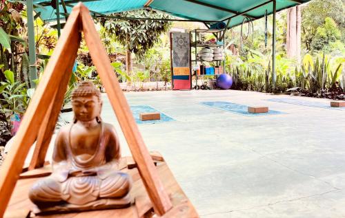 a statue of a buddha sitting in a frame at La Ruka Hostel in Puerto Viejo