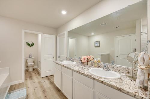 a bathroom with two sinks and a toilet at San Antonio Home with Fenced-In Yard Steps to Park! in San Antonio