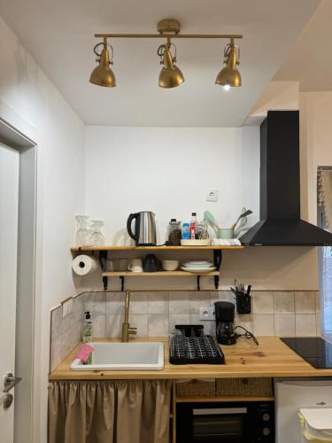 a kitchen with a counter top with a sink at El Mirador de Benialfaqui, Apartamento Els Cireres in Benialfaquí