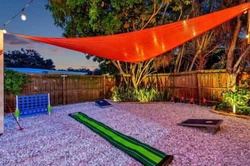 a backyard with a fence and a red tent at King Beds - Game Room - Pool - Beach 2m - 2,100sqft in Largo