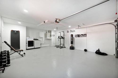 a white room with a gym with music equipment at King Beds - Game Room - Pool - Beach 2m - 2,100sqft in Largo