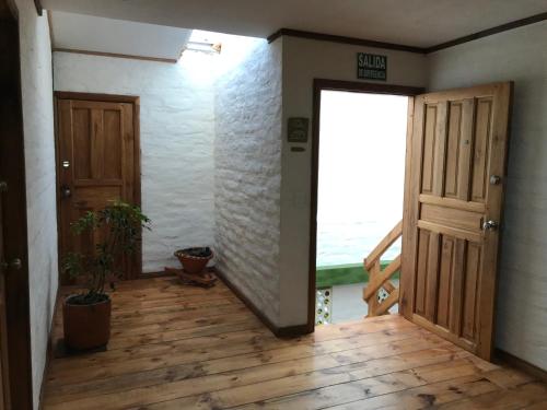 an empty room with a door and a balcony at La Casa Verde Eco Guest House in Baños