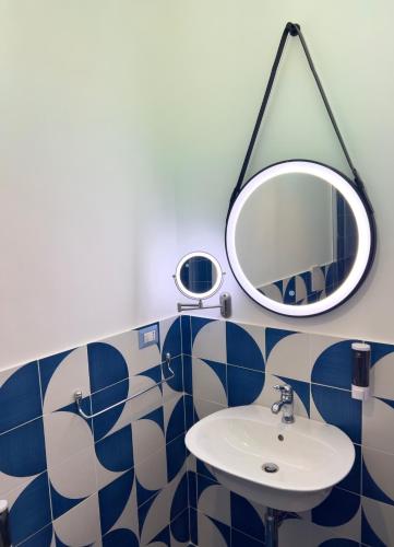 a bathroom with a sink and a mirror at Blu D Alia Exclusive Rooms in Ischia