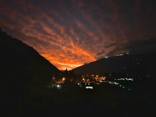 a sunset over a city with a mountain at La Casa Verde Eco Guest House in Baños