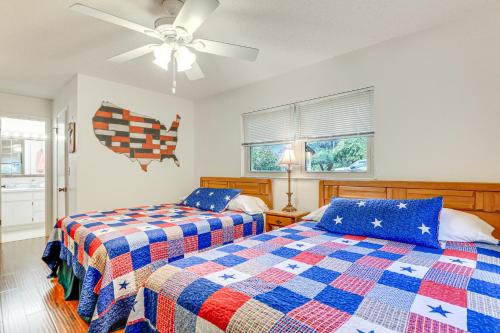a bedroom with two beds and a ceiling fan at Lakefront Frostproof Vacation Rental with Beach! in Frostproof