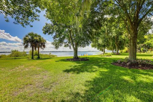 a park with trees and water in the background at Lakefront Frostproof Vacation Rental with Beach! in Frostproof