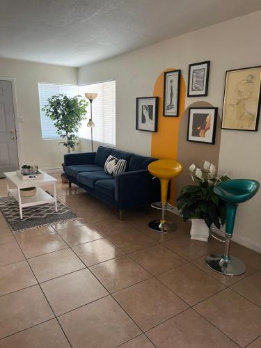 a living room with a blue couch and a table at Rest in Vegas in Las Vegas