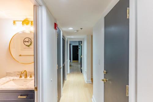 a hallway leading to a bathroom with a sink at Cozy Smoky Mtn 2br Getaway W Pool Fireplace in Gatlinburg