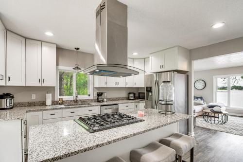 a kitchen with white cabinets and a stove top oven at Renovated Brainerd Cabin on Lake Fish and Swim! in Brainerd
