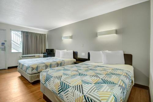 a hotel room with two beds and a window at Motel 6-Lima, OH in Lima