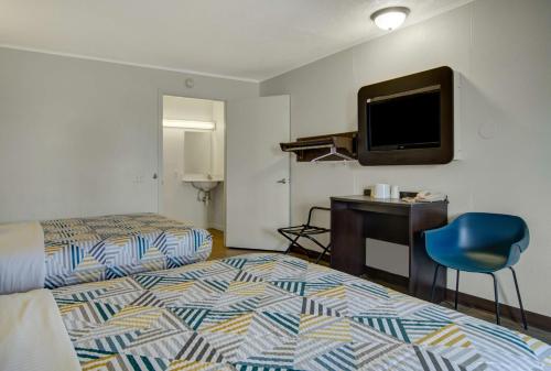 a hotel room with two beds and a flat screen tv at Motel 6-Lima, OH in Lima