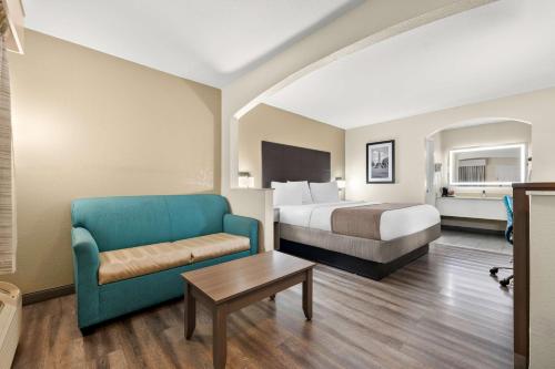 a hotel room with a bed and a couch at Best Western Catalina Inn in Tuscaloosa