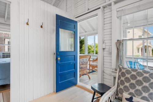 a blue door in a white room with a bench at 17 Captain Dunbar Road Brewster - Prestons Haven in Brewster