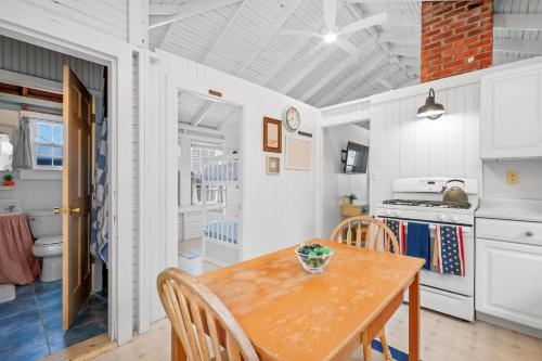 a kitchen and dining room with a wooden table at 17 Captain Dunbar Road Brewster - Prestons Haven in Brewster