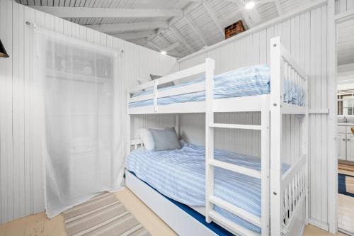 a bedroom with bunk beds in a white room at 17 Captain Dunbar Road Brewster - Prestons Haven in Brewster