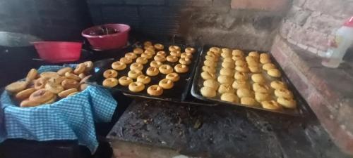 a bunch of donuts and other food on a table at El Monolito Camping in Ubaque