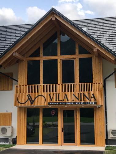 a building with a balcony on top of it at Vila Nina Bohinj in Bohinj