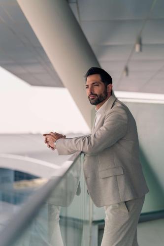 a man in a suit standing next to a wall at Radisson Blu Hotel Riyadh Convention and Exhibition Center in Riyadh