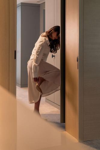 a woman is standing in front of a mirror at Radisson Blu Hotel Riyadh Convention and Exhibition Center in Riyadh