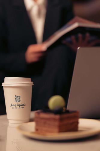 a cup of coffee and a plate of food with a cup of coffee at Radisson Blu Hotel Riyadh Convention and Exhibition Center in Riyadh
