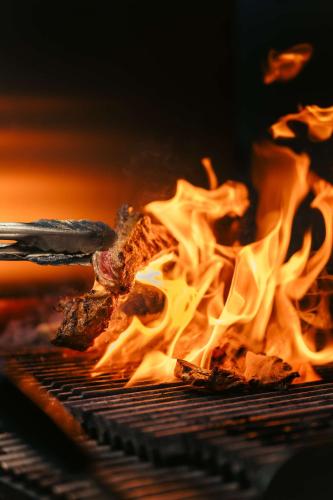 a close up of a grill with fire at Radisson Blu Hotel Riyadh Convention and Exhibition Center in Riyadh