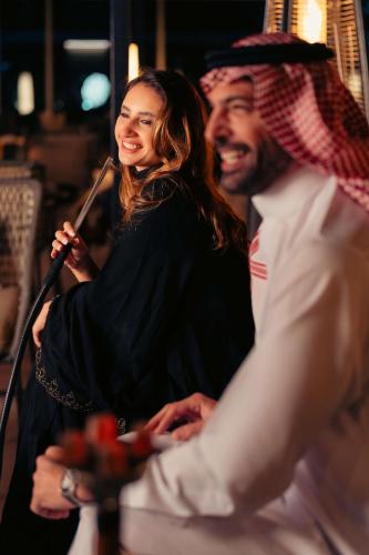 a man and a woman singing into a microphone at Radisson Blu Hotel Riyadh Convention and Exhibition Center in Riyadh